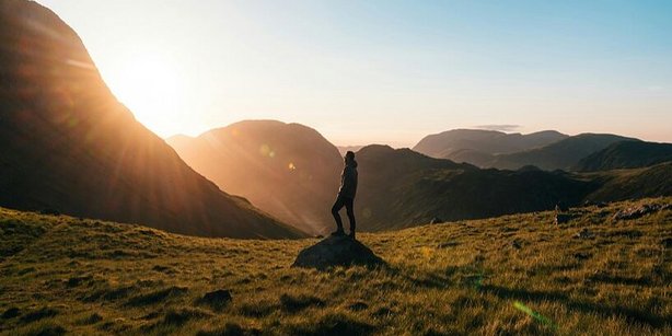A hiker watching the sunset.